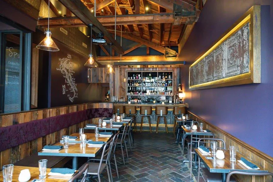 Dark dining room interior with wine bottles at Eduardo's Enoteca Gold Coast